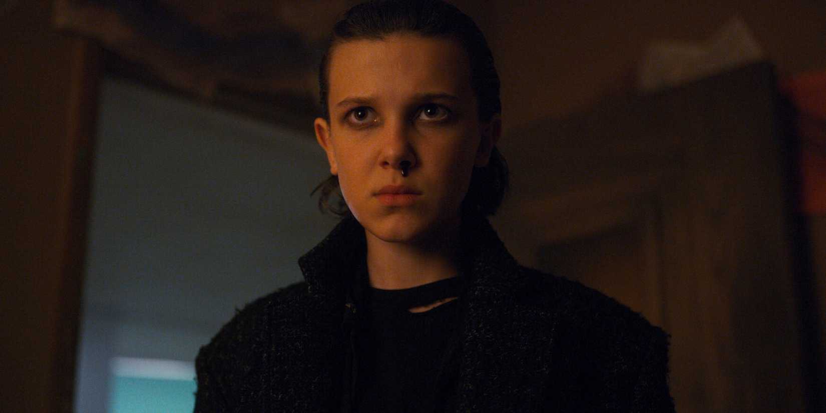 Millie Bobby Brown as Eleven with eyeliner, slicked back hair, and a bloody nose in Stranger Things season 2.