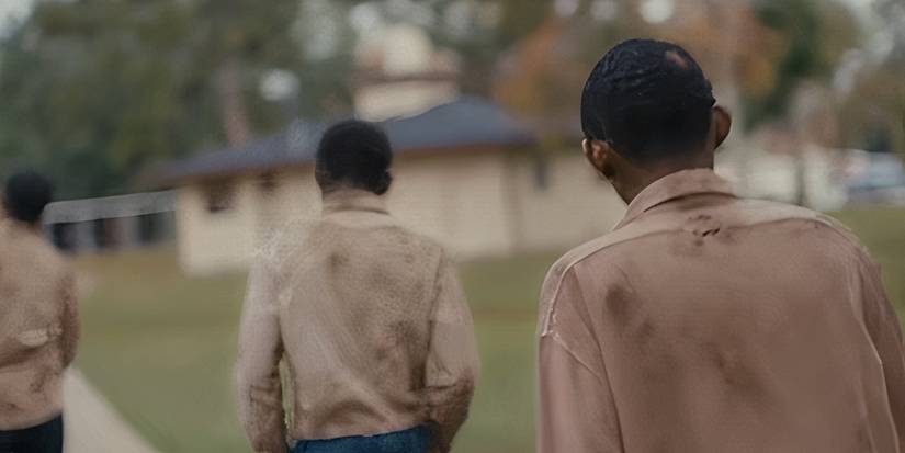 Three men walking together in Nickel Boys