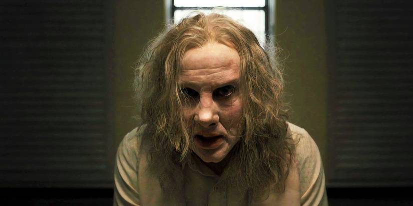 Nicolas Cage wearing prosthetics and staring intensely ahead as Longlegs