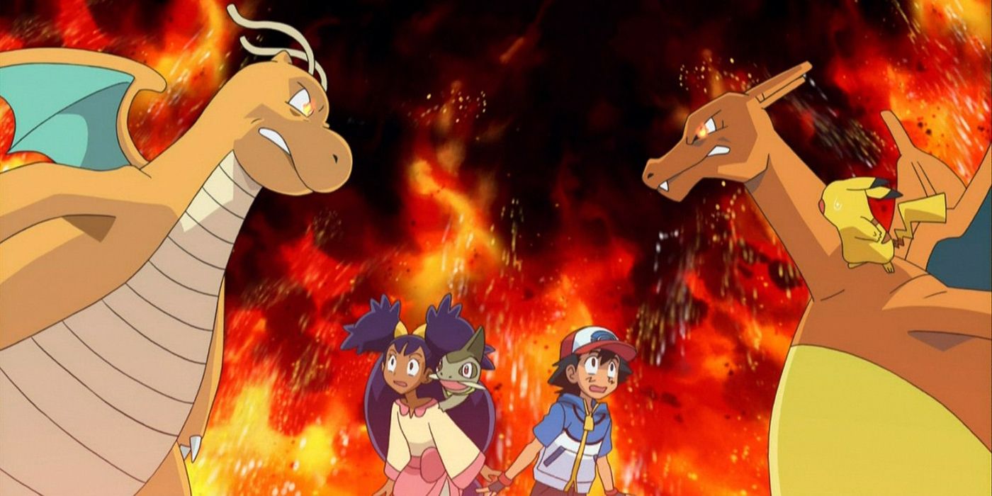 Dragonite and Charizard stare each other down as Ash and Iris look on.