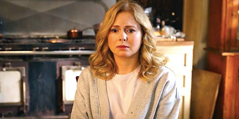 Rose McIver's Sam sits at the kitchen table looking worried in Ghosts season 4 episode 5