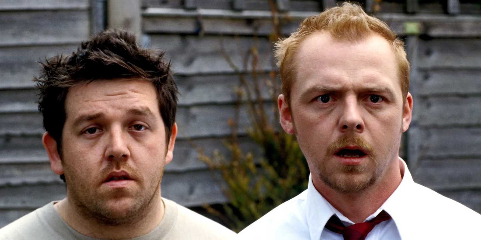 Shaun (Simon Pegg) and Ed (Nick Frost) stare dumbfounded off-screen in Shaun of the Dead (2004).