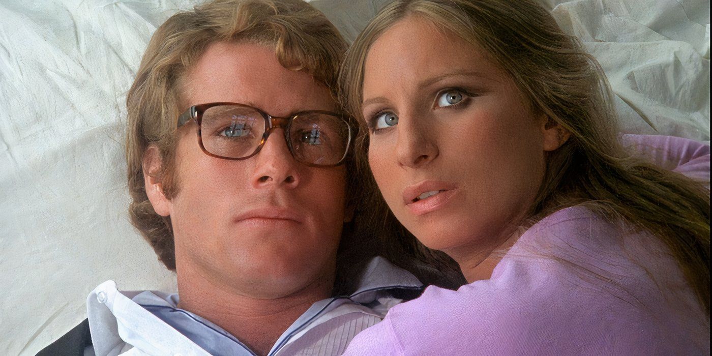 Ryan O'Neal and Barbra Streisand as Howard and Judy lying in bed together in What's Up Doc