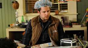 Shawn in a shower cap surveying his office in Late Night Gus episode of Psych