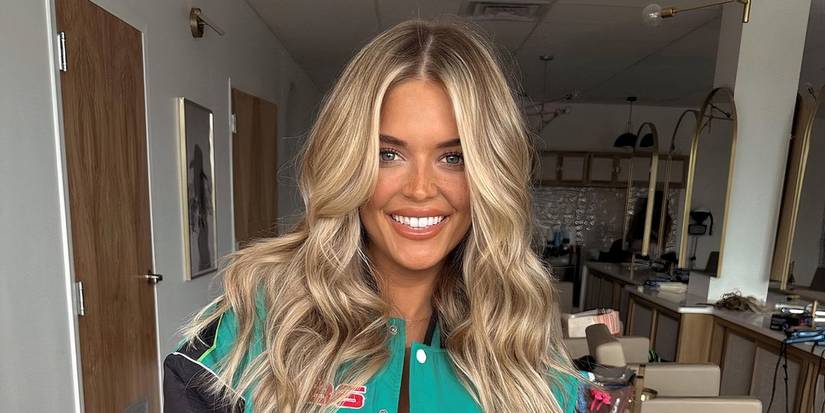 Southern Charm season 10 Salley Carson smiling while taking a photo with her blonde hair touching her shoulders