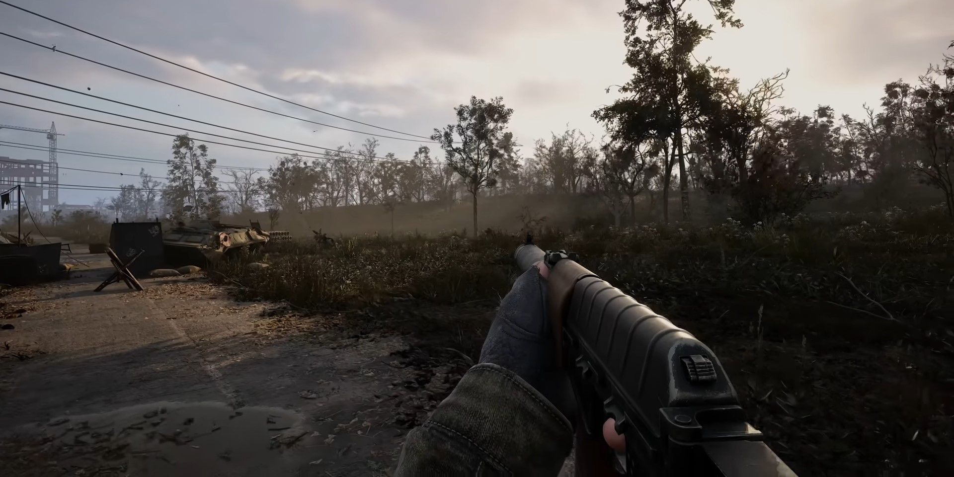 The player walking through the zone while holding an assault rifle in Stalker 2.