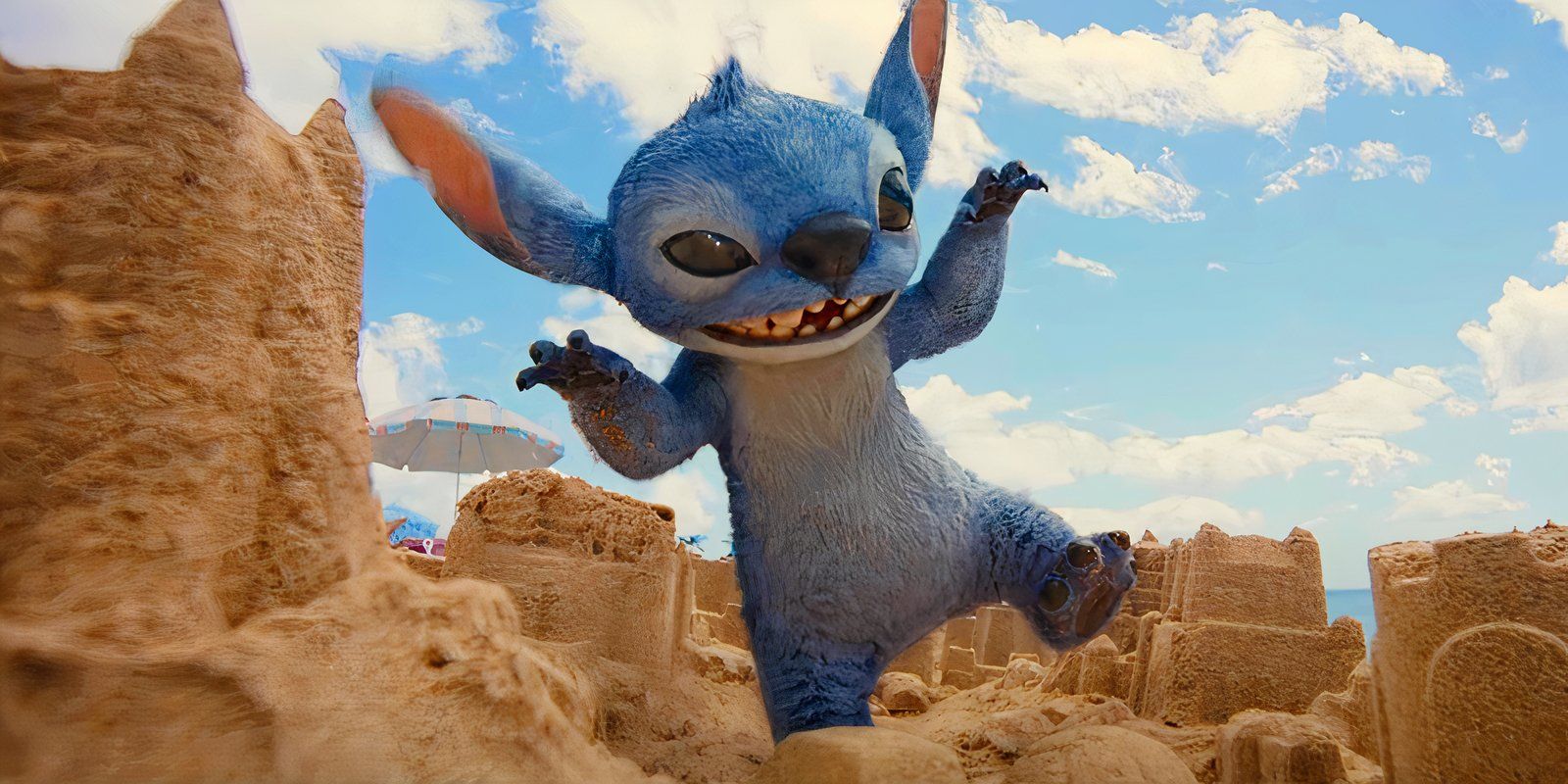 Stitch on the beach by sand castles in the live-action Lilo & Stitch