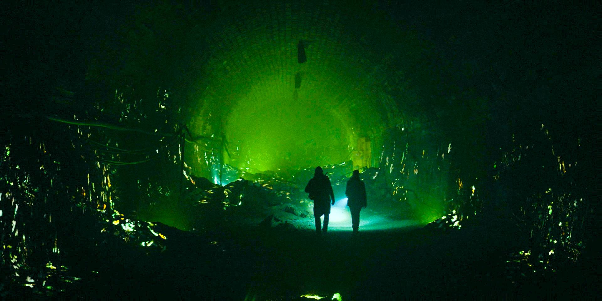 Carol (Meslissa McBride) and Daryl (Norman Reedus) walking through a brilliant tunnel on The Walking Dead: Daryl Dixon.