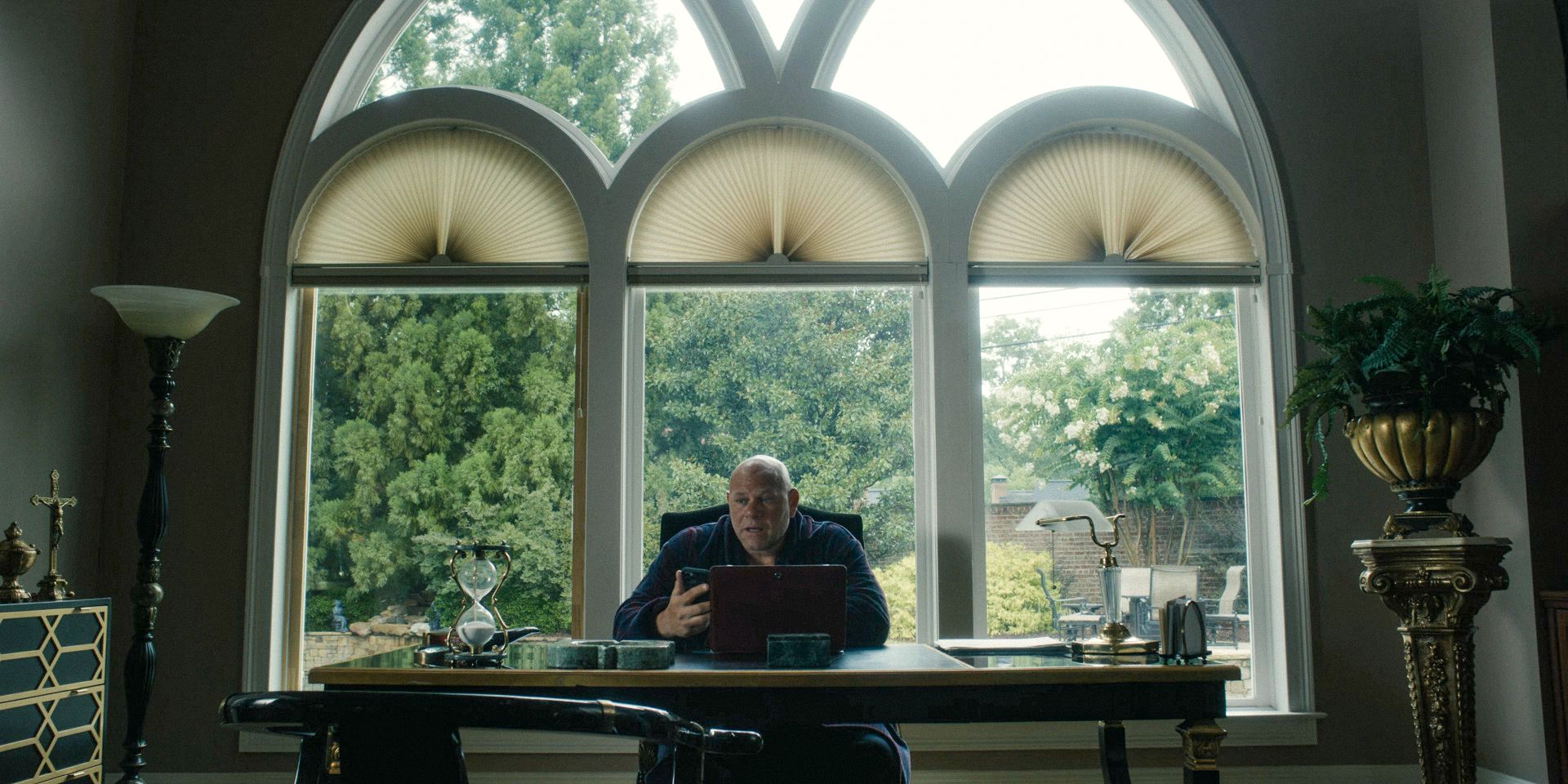 a man sitting at a desk in a home office in Tulsa King