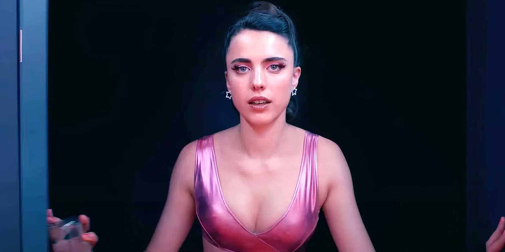 Margaret Qualley as Sue walking through a door intensely in The Substance