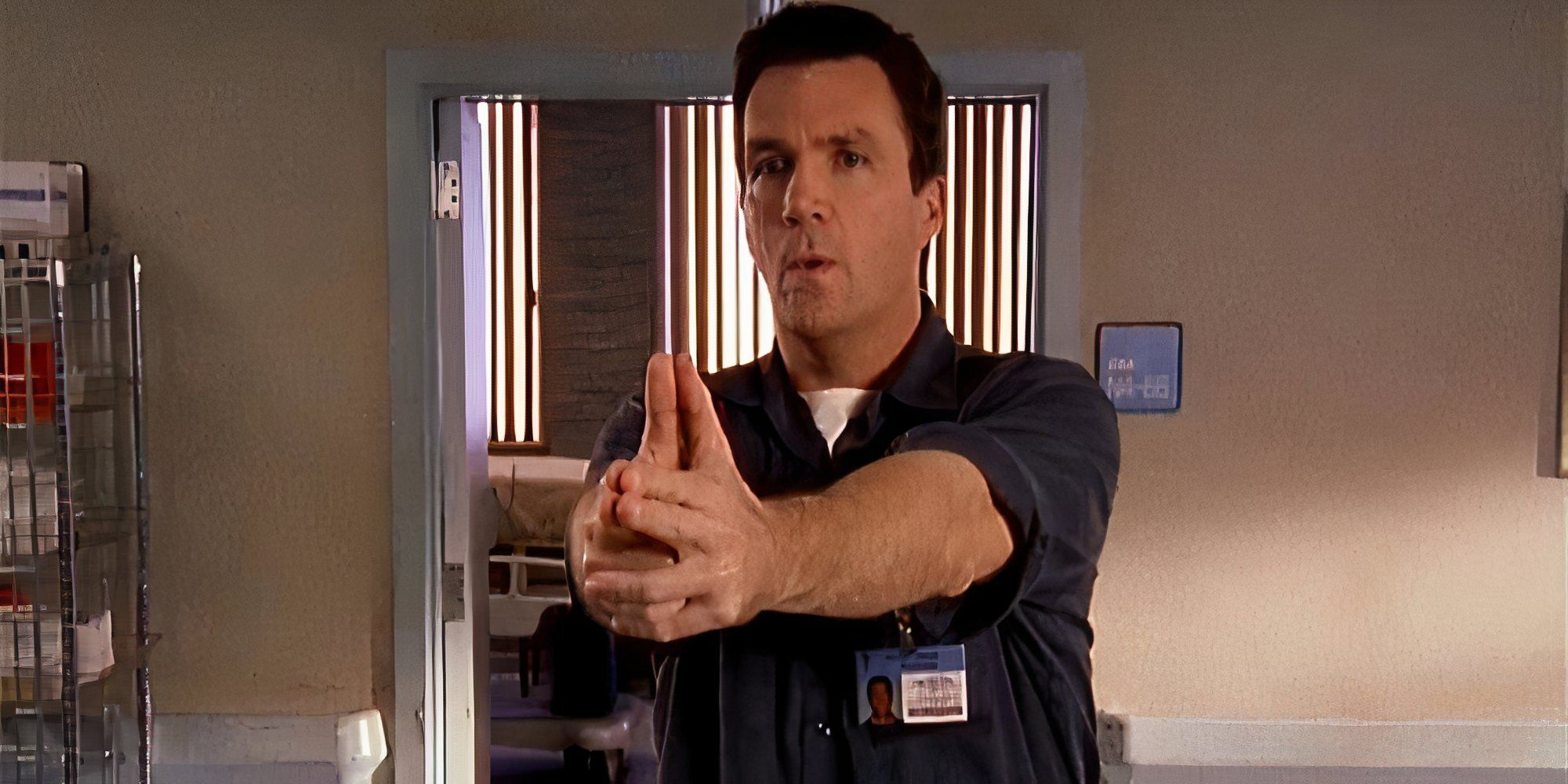 Neil Flynn aiming his fingers as a gun as the Janitor in Scrubs