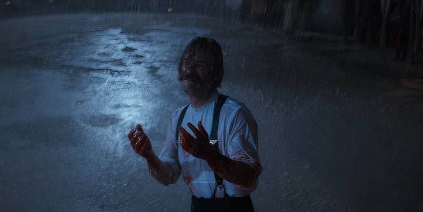 Wyatt Earp (Kurt Russell) crying in the rain with bloodsoaked hands in Tombstone