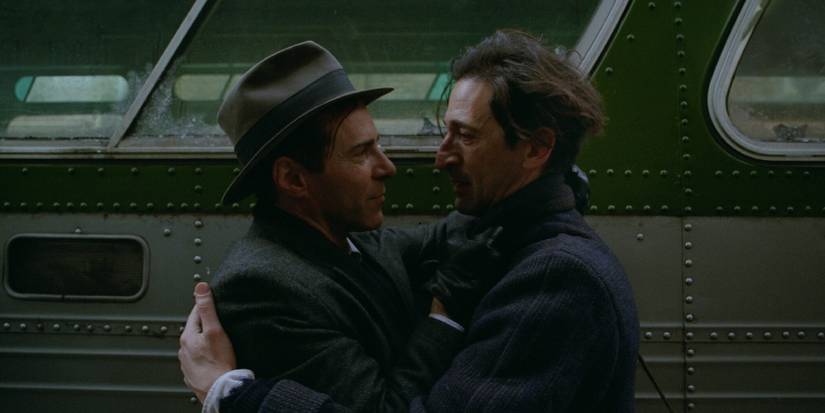 Adrien Brody and Guy Pearce hugging in The Brutalist