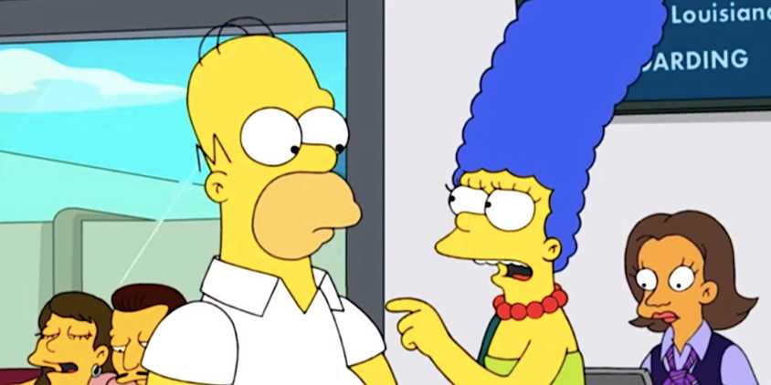 An angry Marge points a finger at Homer in an airport check in desk from The Simpsons season 36