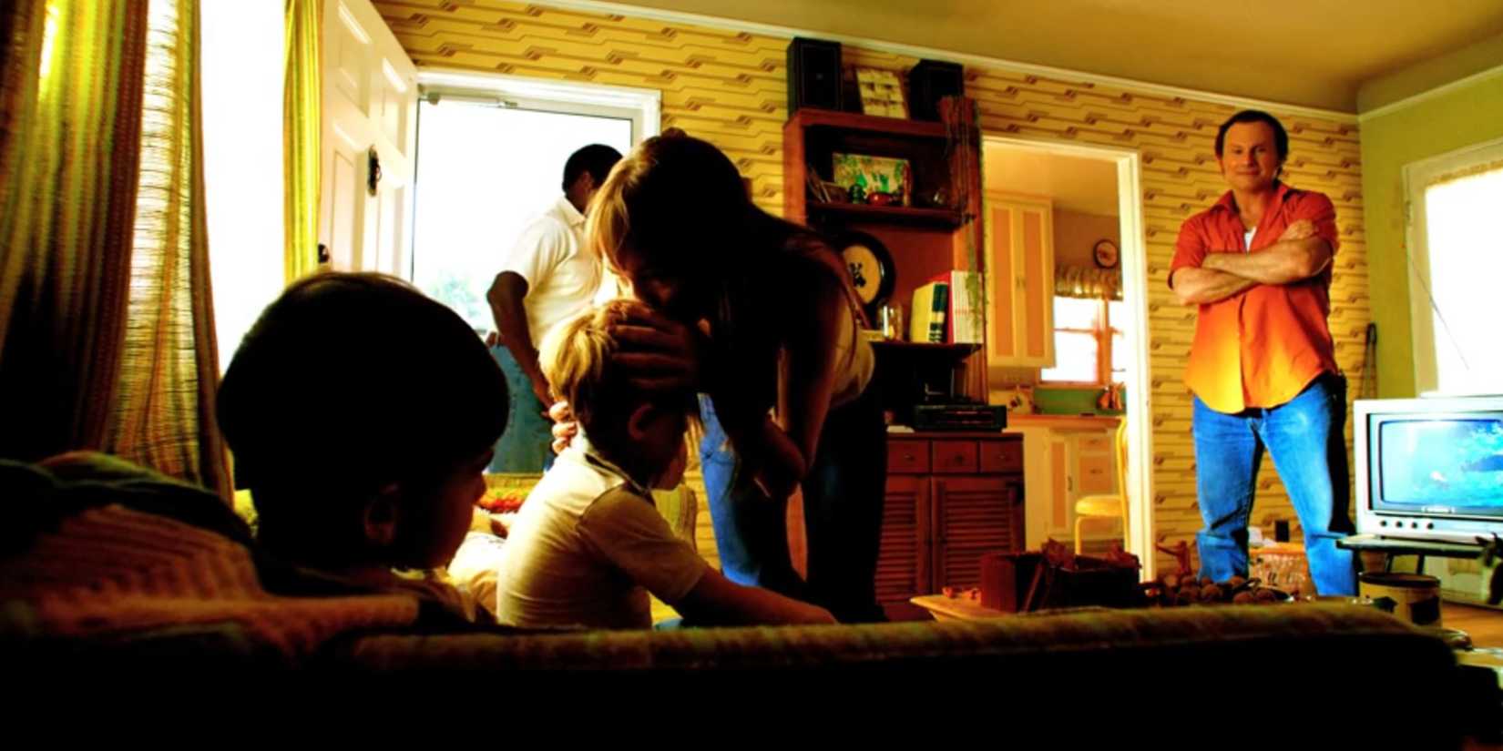Laura Moser (Brittany Allen) kisses Dexter on the head while Harry Morgan (Christian Slater) watches in Dexter: Original Sin