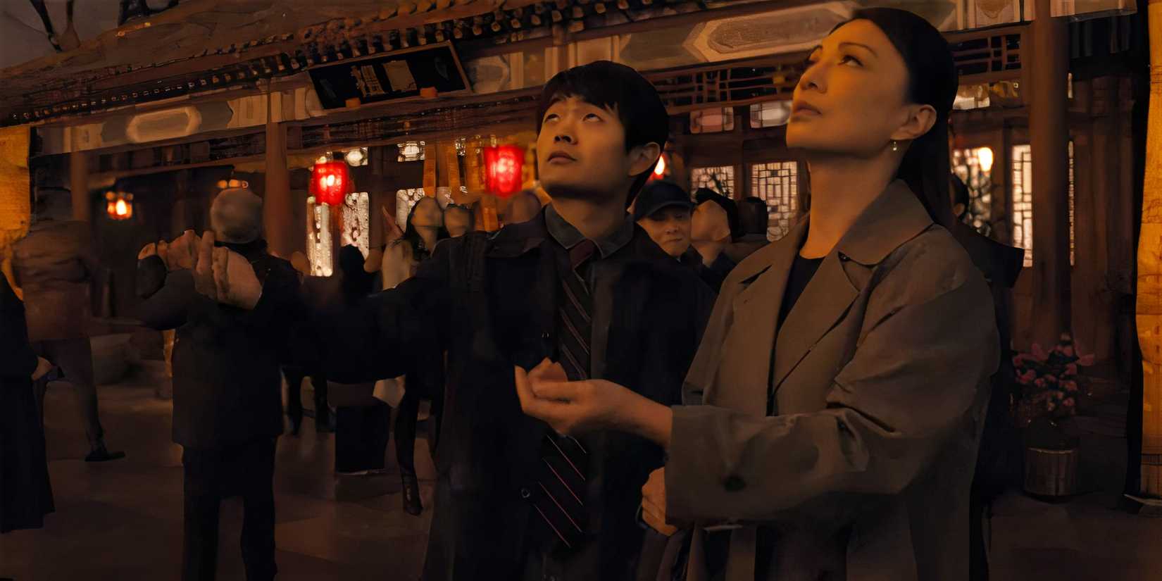 Ben Wang's Li Fong and Ming-Na Wen as his mom looking up to the sky in Karate Kid Legends