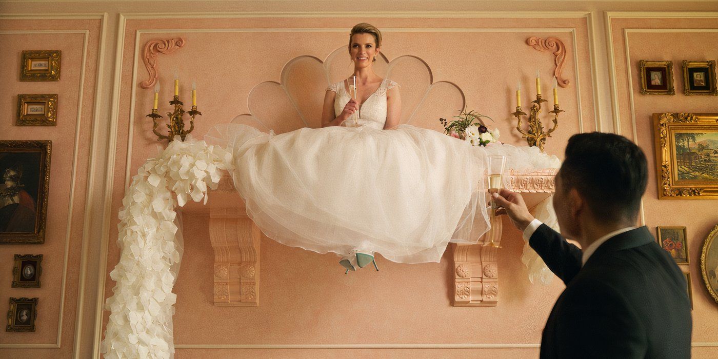 Betty Gilpin in a wedding dress with a glass of champagne on a shelf in Roar