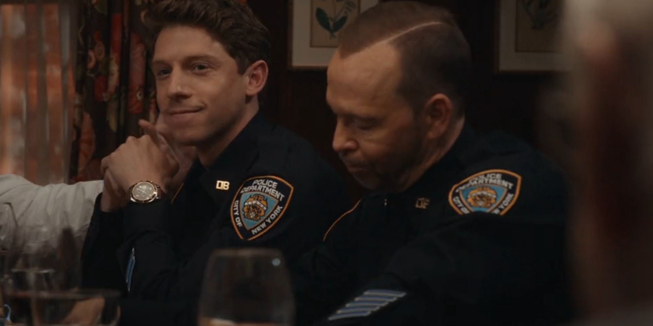 Blue Bloods Frank's arm patting Joe on the back while Joe sits next to Danny