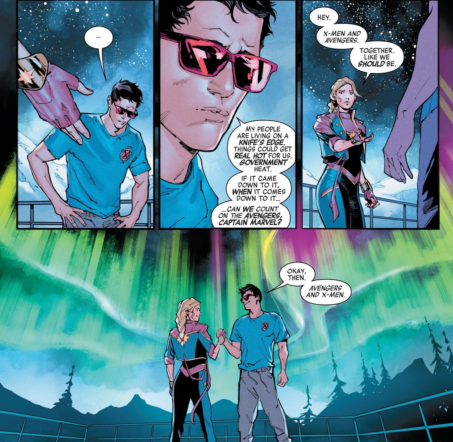 Captain Marvel and Cyclops shake hands on an new alliance in front of the Northern Lights
