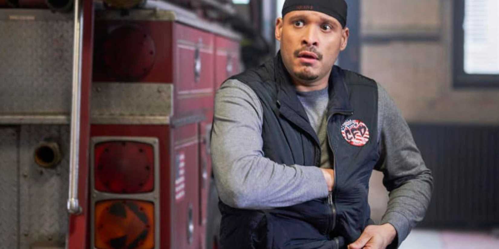 Chicago Fire Cruz standing in a warehouse with his hand in his pocket under his vest