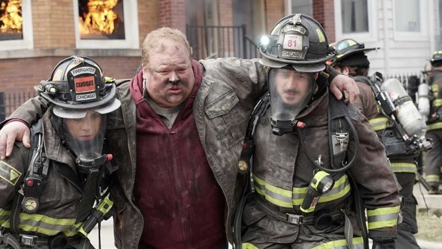Chicago Fire The firefighters walk an injured man out of a fire