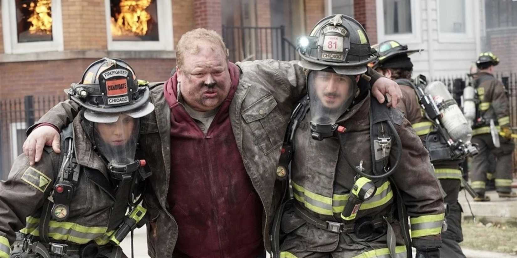 Chicago Fire The firefighters walk an injured man out of a fire