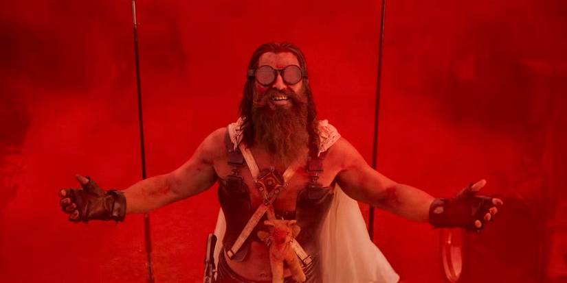 Chris Hemsworth surrounded by red smoke in Furiosa A Mad Max Saga