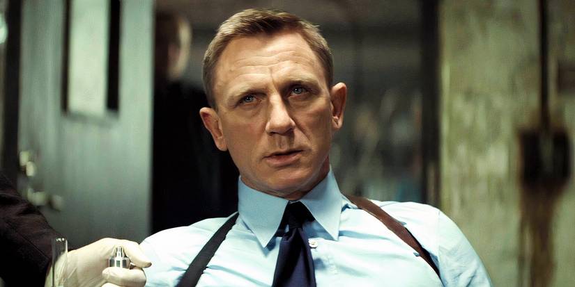 Daniel Craig as James Bond looking annoyed while sitting in Spectre