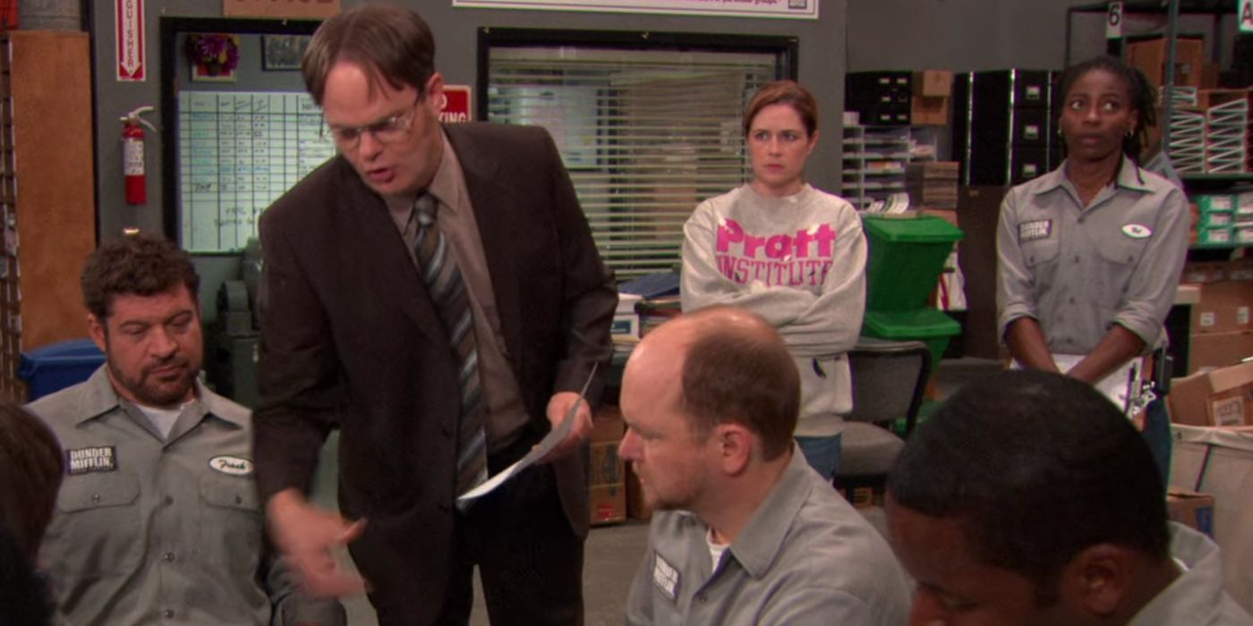 Dwight (Rainn Wilson) talking to the warehouse workers while Pam (Jenna Fischer) looks on in The Office.