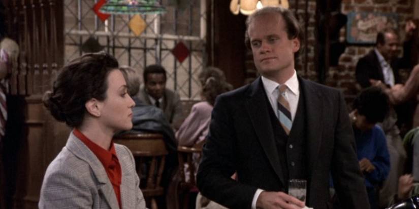 Lillith (Bebe Neuwirth) and Frasier Crane (Kelsey Grammer) looking at one another in the bar in Cheers season 5, episode 4.