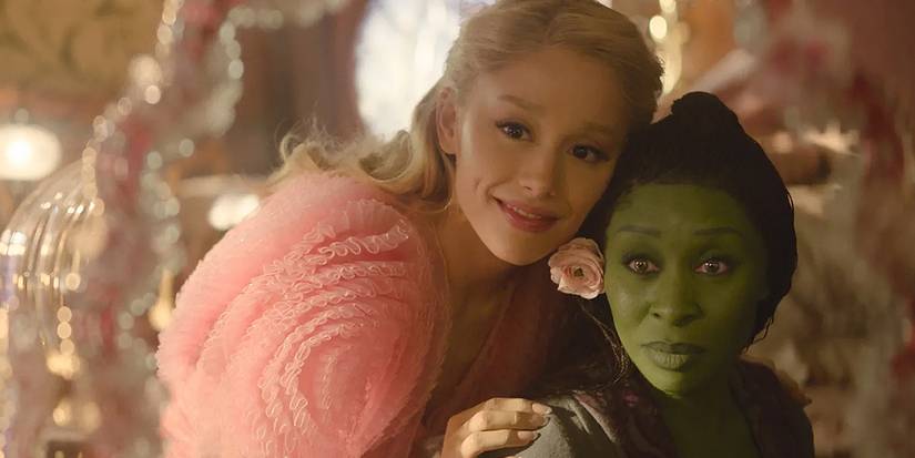 Ariana Grande as Galinda and Cynthia Erivo as Elphaba looking in the mirror during the Popular sequence in Wicked