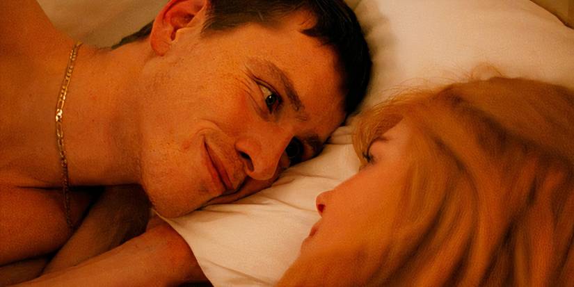 Harris Dickinson and Nicole Kidman lying in bed together in Babygirl