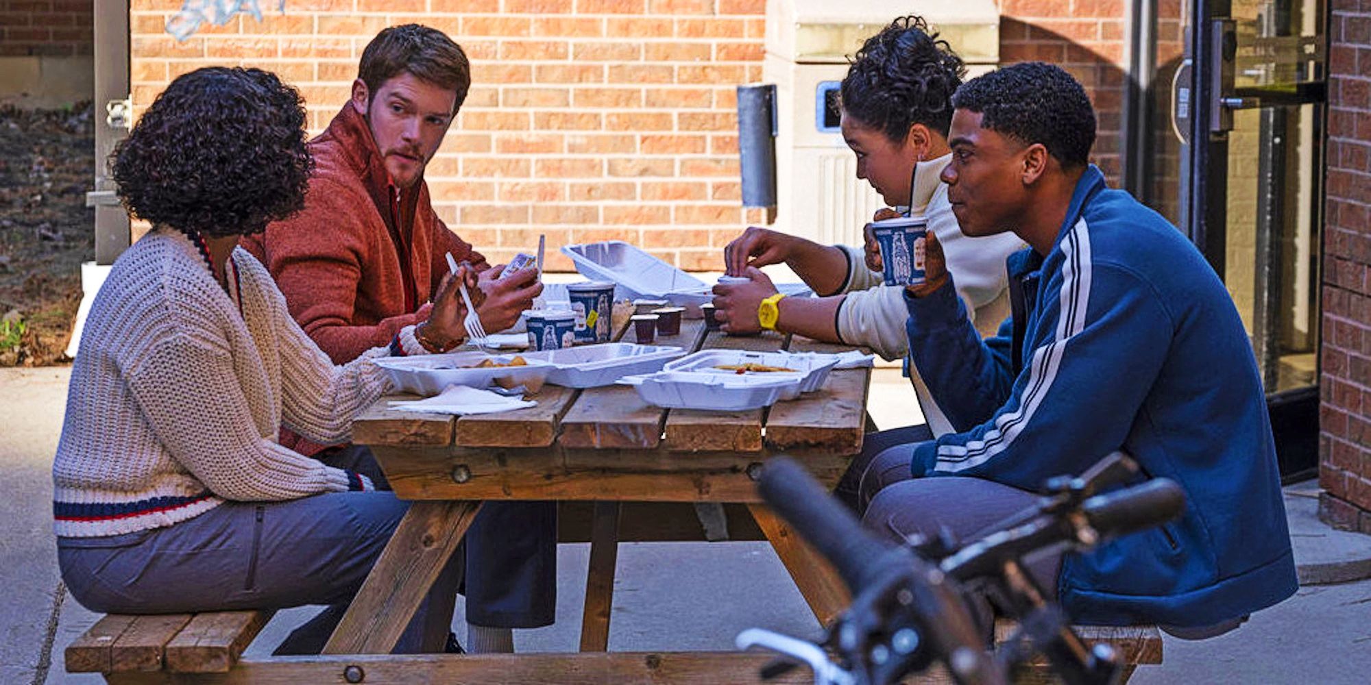 Ashleigh LaThrop, Alex MacNicoll, Spence Moore II, and Aury Krebs as Ericka, Van, Jacob, and Dana around a picnic table in Brilliant Minds