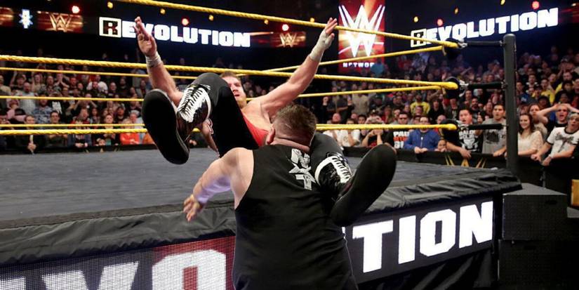 Kevin Owens hits Sami Zayn with a powerbomb on the apron at NXT TakeOver R Evolution