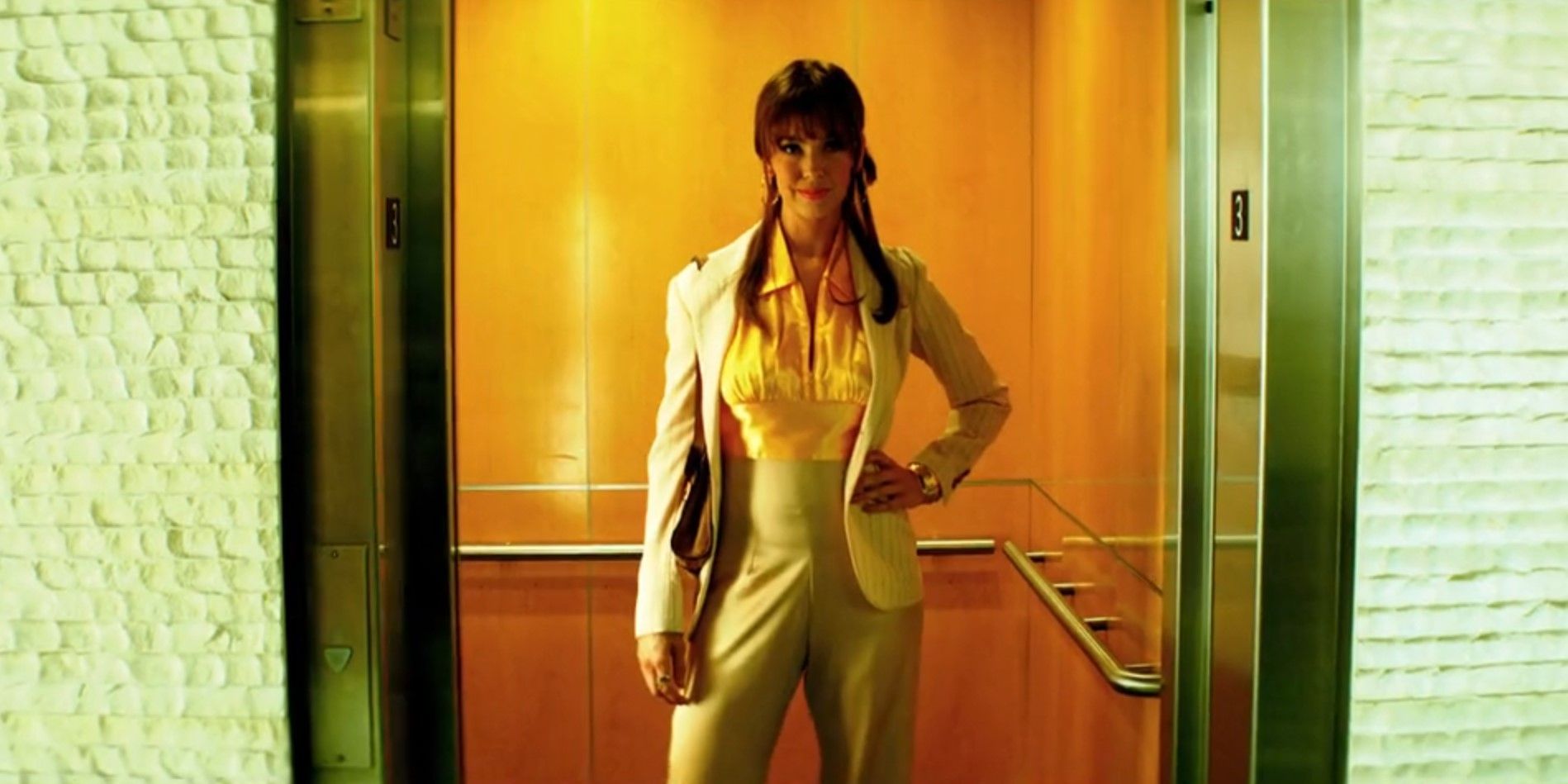 Laura Moser (Brittany Allen) standing in an elevator wearing a pantsuit in Dexter: Original Sin season 1, episode 3