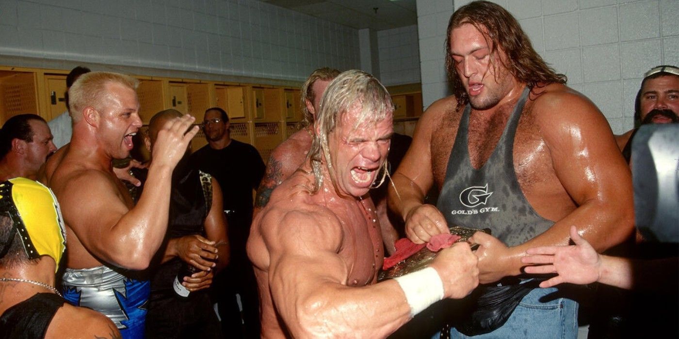 Lex Luger celebrates winning the WCW World Heavyweight Championship in the locker room with the roster including Rey Mysterio Big Show The Giant and Rick Steiner