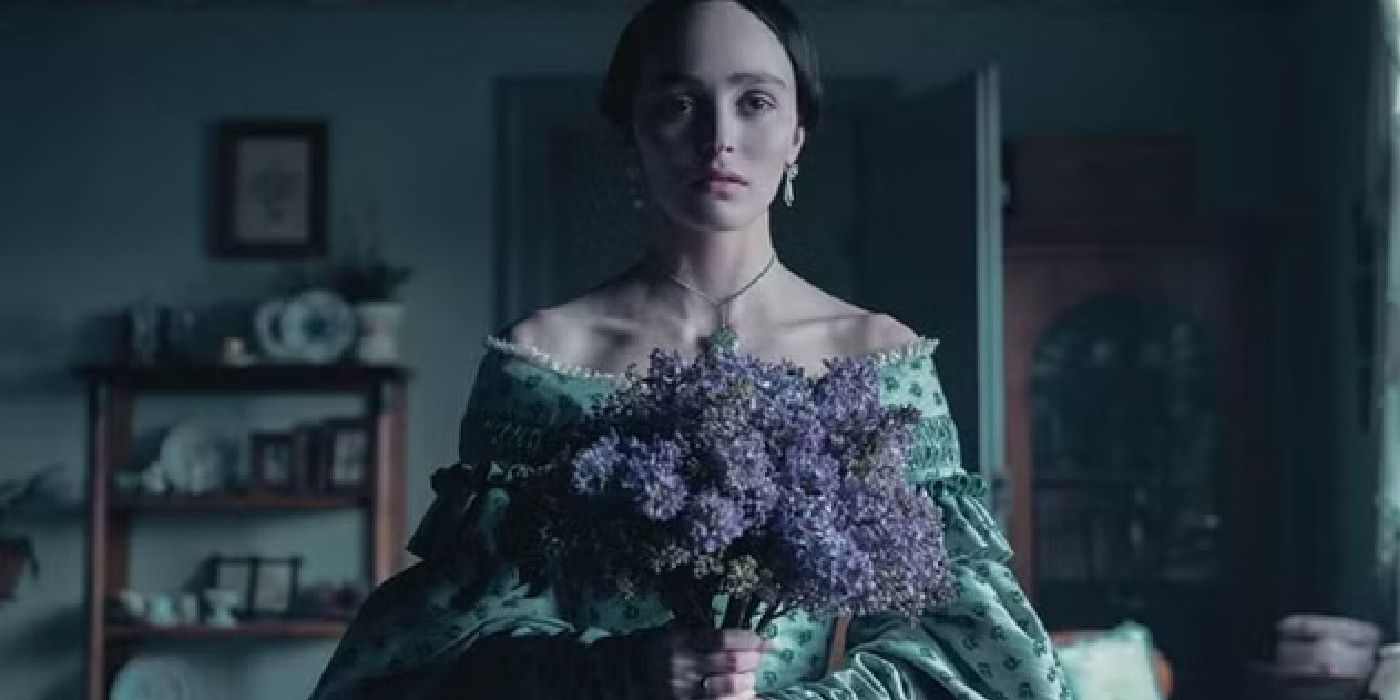 Lily-Rose Depp as Ellen Hutter holding flowers in Nosferatu