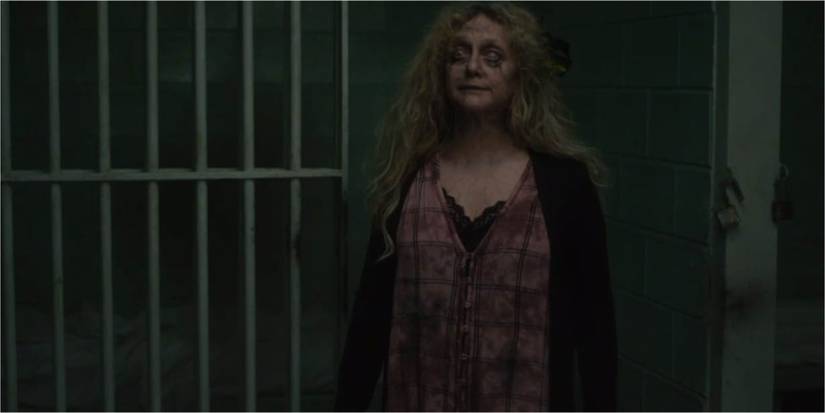 Mallory standing outside her cell after she rises as a zombie