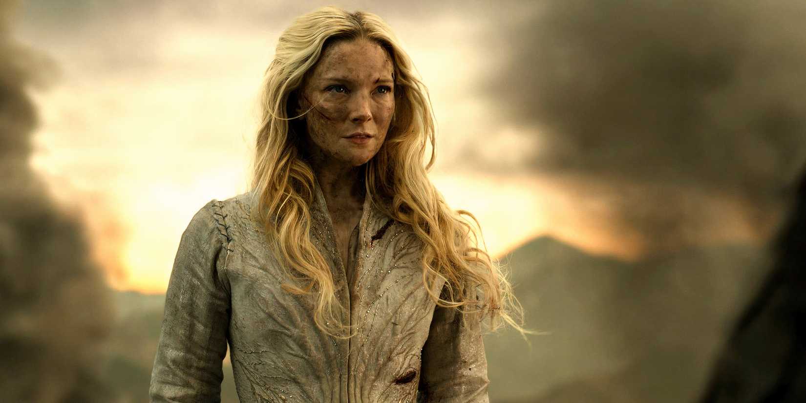 Morfydd Clark as Galadriel cut up and looking intensely at Charlie Vickers as Sauron with a cliff behind her in The Lord of the Rings The Rings of Power season 2 finale.