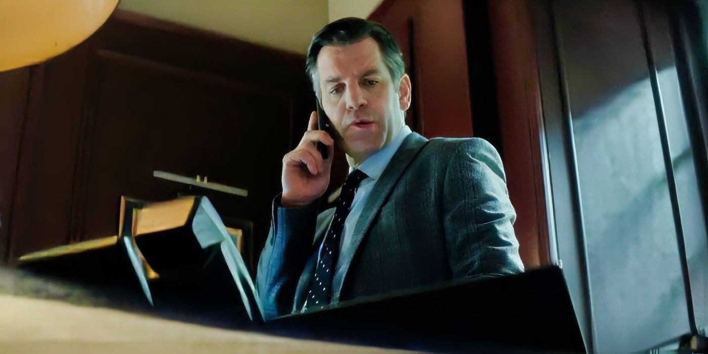 Paris Has Fallen DCX Capital villain Richard (John Hopkins) talking into a phone