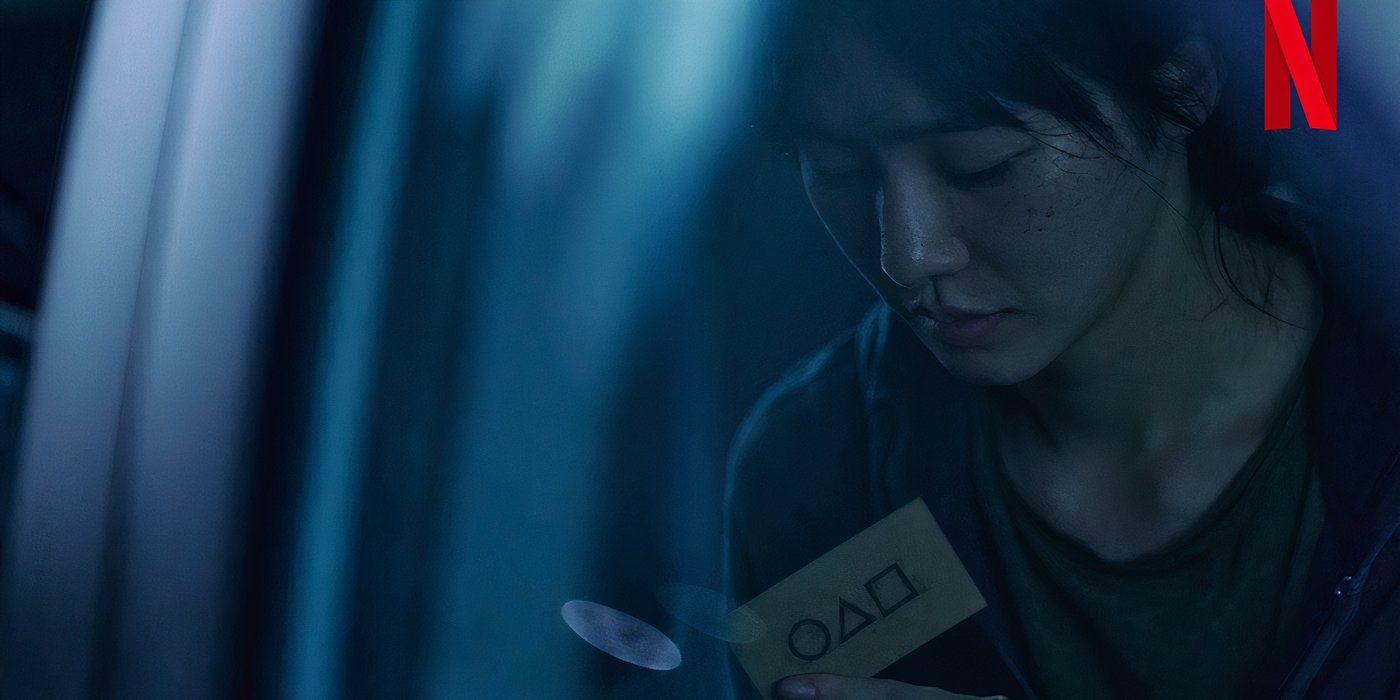 Park Gyu-young's character looking at the Squid Game calling card in Squid Game season 2