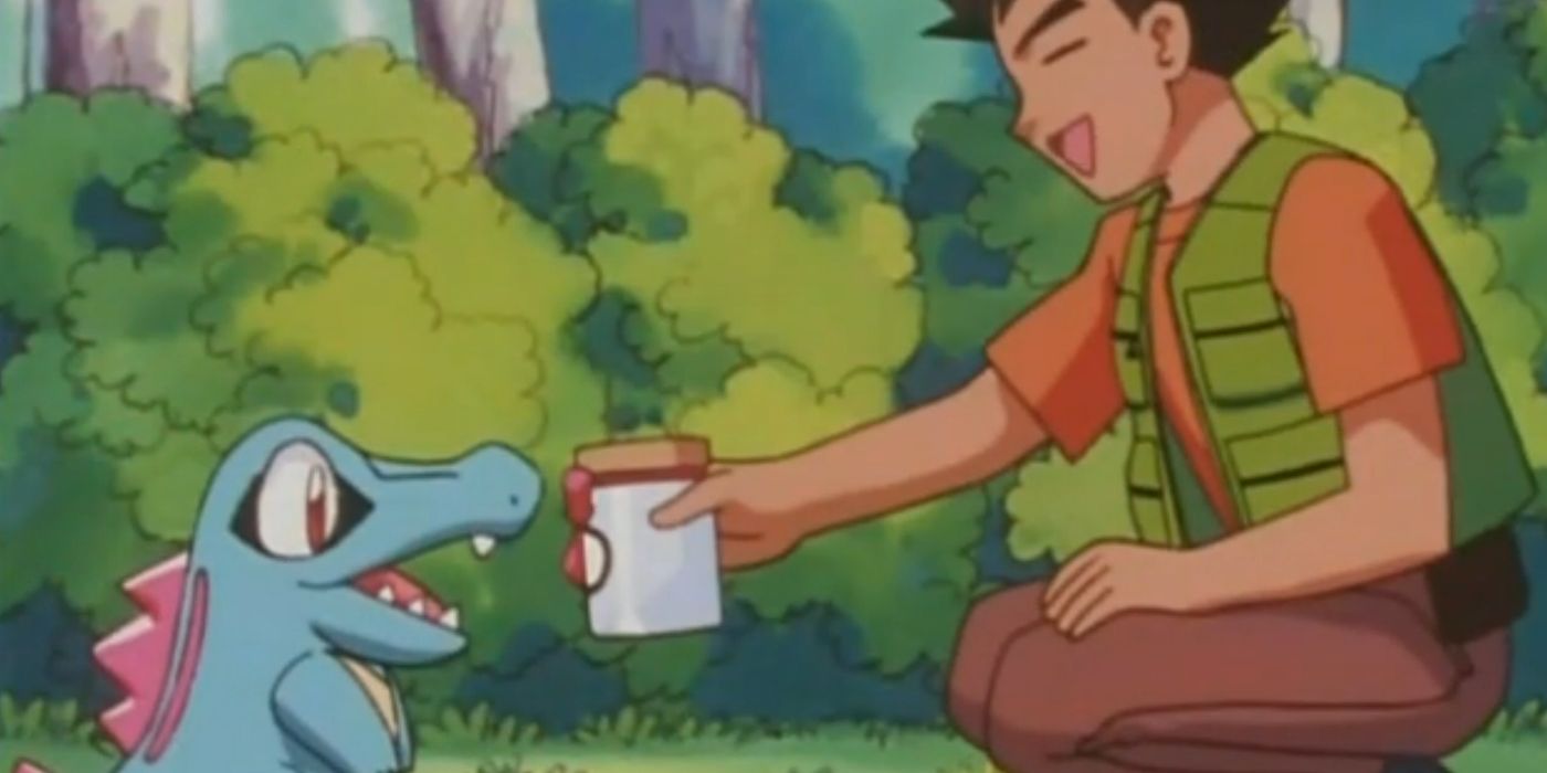 Brock oferece ao Totodile um pote de guloseimas para cortejar Azumarill.