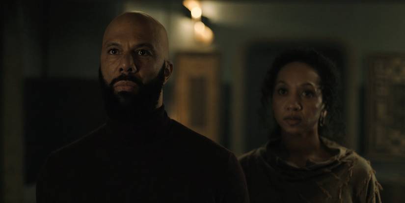 Robert Sims and Camille Sims looking at Bernard in their kitchen in Silo season 2's episode 5