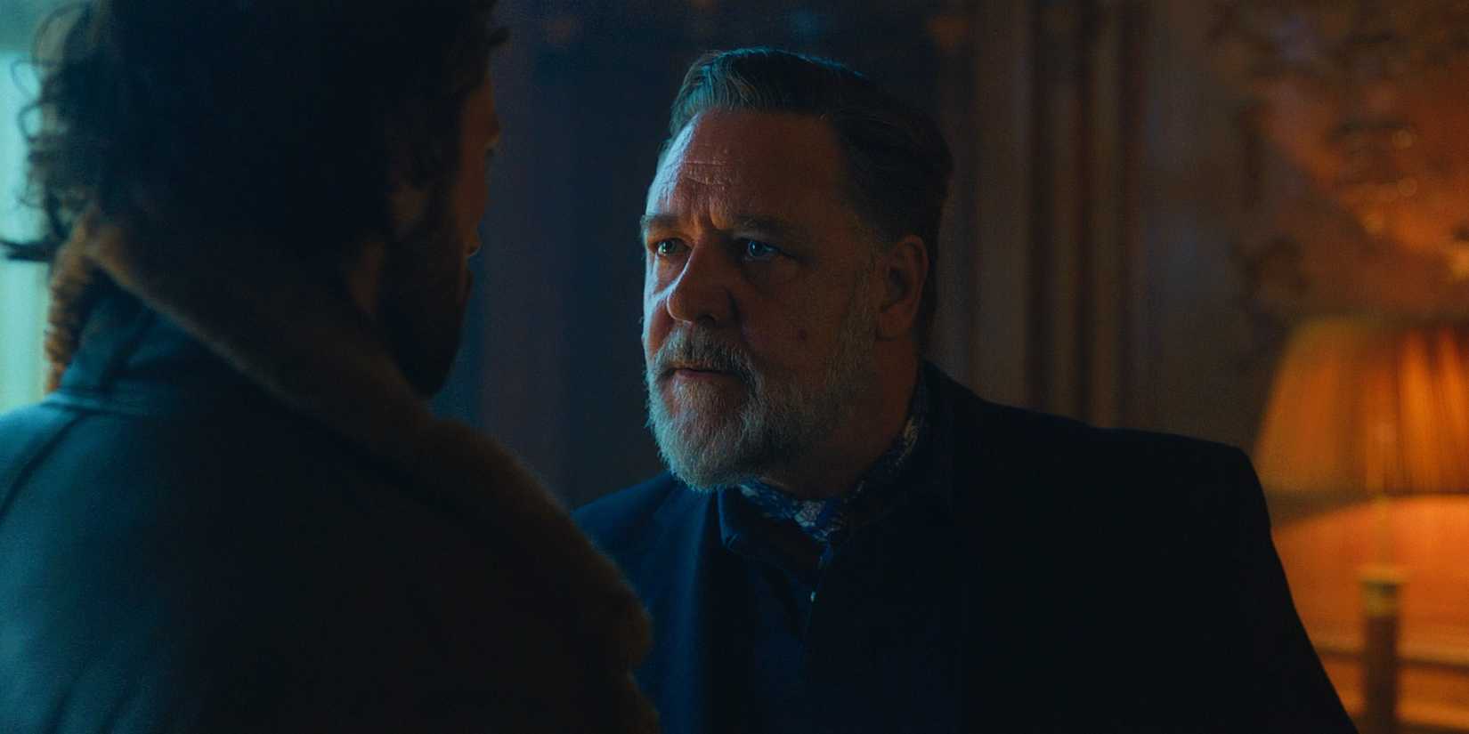 Russell Crowe as Nikolai Kravinoff talking to Sergei in his home office in Kraven the Hunter