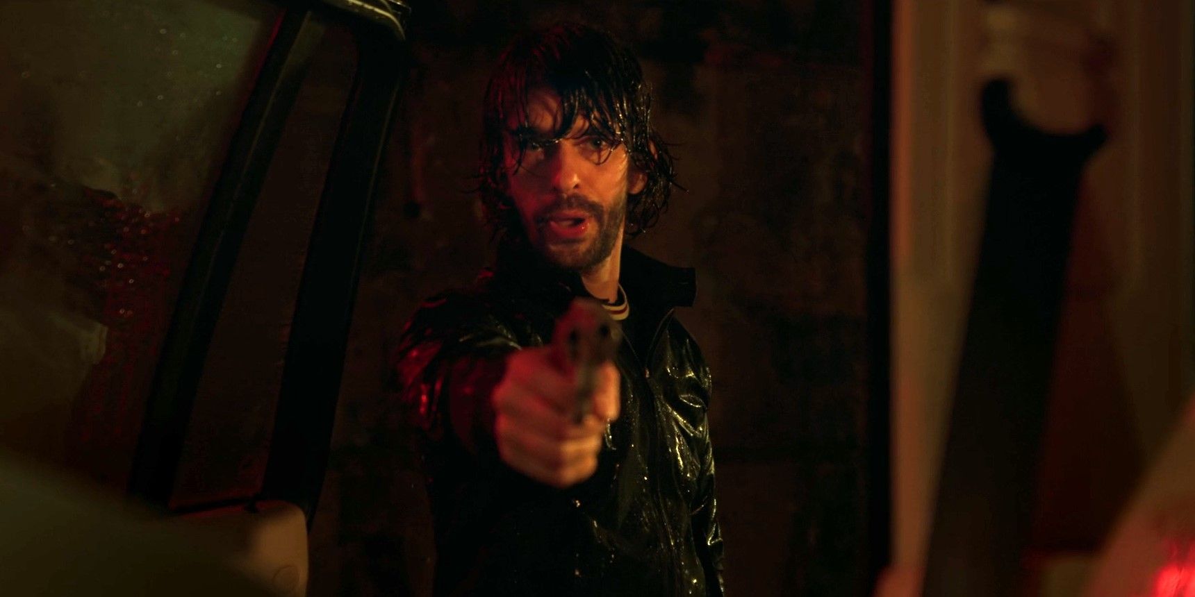 Sam Young (Ben Whishaw) points a pistol at Hector in the rain in Black Doves