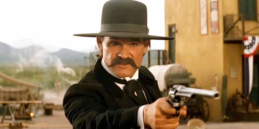 Kurt Russell as Wyatt Earp brandishing his Peacemaker gun in Tombstone