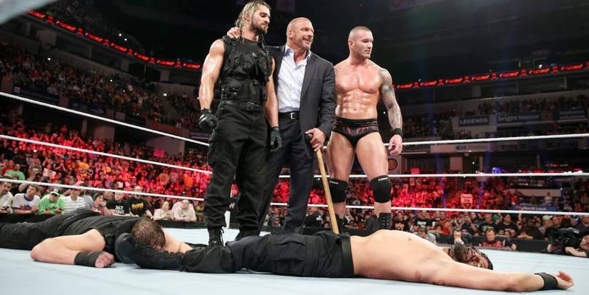 Seth Rollins stands with Triple H and Randy Orton over Roman Reigns and Dean Ambrose's bodies after betraying The Shield on WWE Monday Night Raw