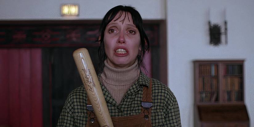 Shelley Duvall holding a bat and looking distraught as Wendy Torrance in The Shining