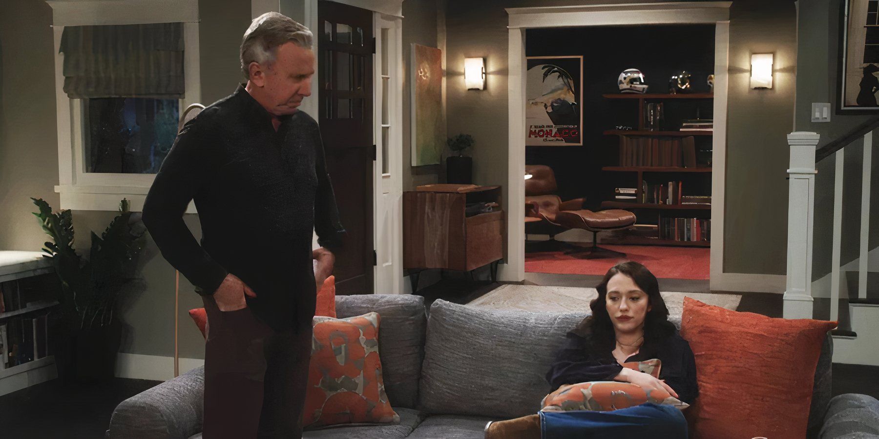 Tim Allen as Matt standing next to Matt's daughter, Kat Dennings, who sits on the couch looking defeated in Shifting Gears