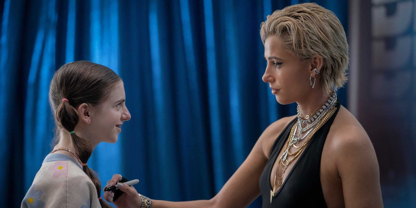 Skye signs a fan's shirt in Smile 2